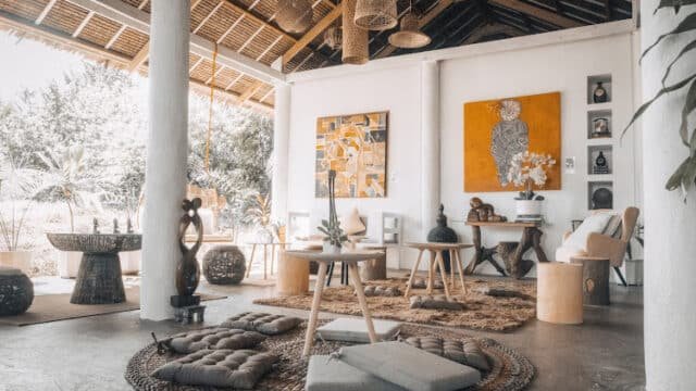 Boho-style living room with earthy tones, low seating, woven rugs, artwork, Siargao accents, and natural light.
