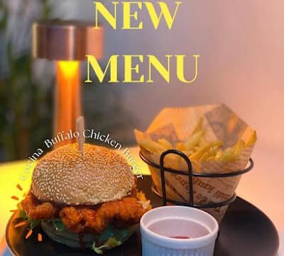 Buffalo chicken burger, fries, and ketchup on a plate—Siargao’s NEW MENU favorite!